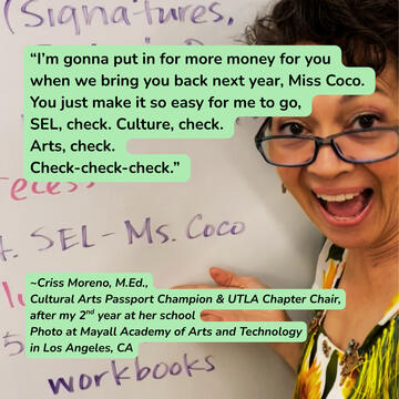 Miss Coco smiling in front of a white board with "SEL - Miss Coco" written by the teacher.