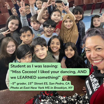 Students in front of stage with Miss Coco in a group selfie.